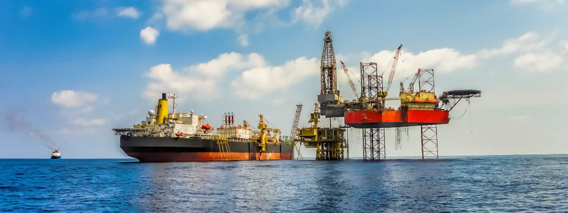 FPSO vessel alongside jack-up rigs offshore